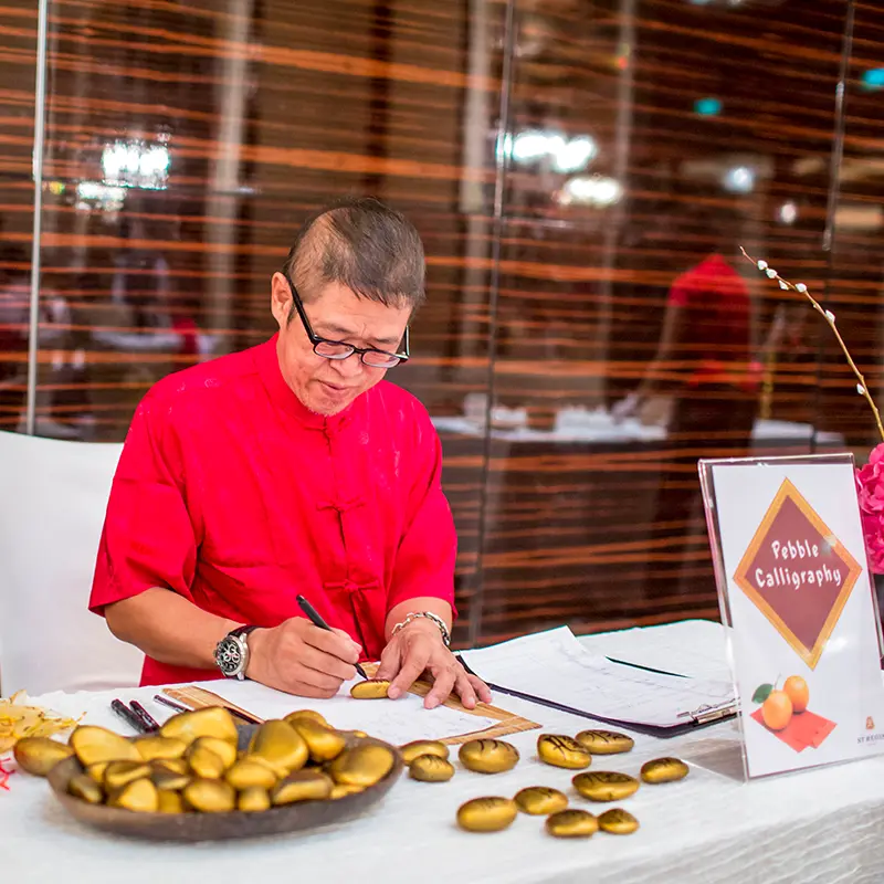 English Names in Chinese Calligraphy Art on Pebble - Chinese New Year Activities - Dinner and Dance - Pre-Event Activities - Event Services Singapore